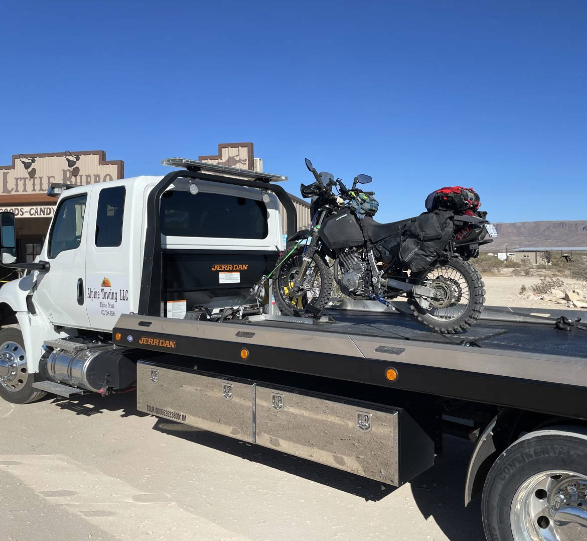 Motorcycle-being-towed-on-a-flatbed-tow-truck-in-Alpine-Texas-by-Alpine-Towing Motorcycle being towed on a flatbed tow truck in Alpine Texas by Alpine Towing