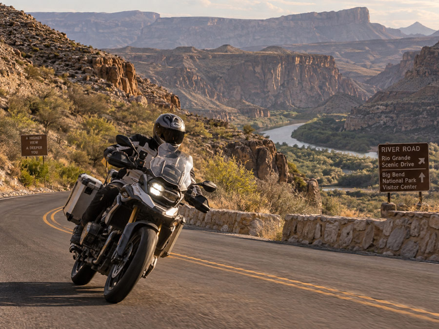 Motorcycle-traveling-on-Big-Bend-river-road-curve-with-the-desert-and-rio-grand-behind Motorcycle traveling on Big Bend river road curve with the desert and rio grande behind